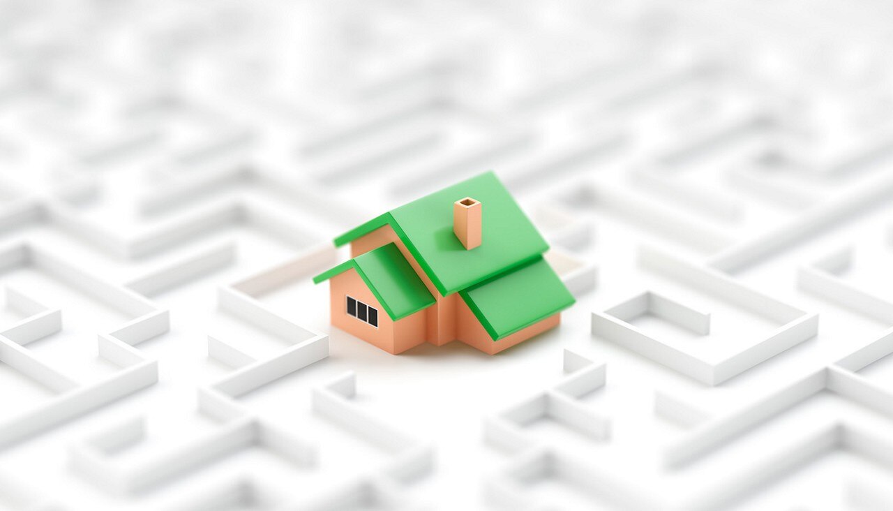 Small toy house in the middle of endless white maze