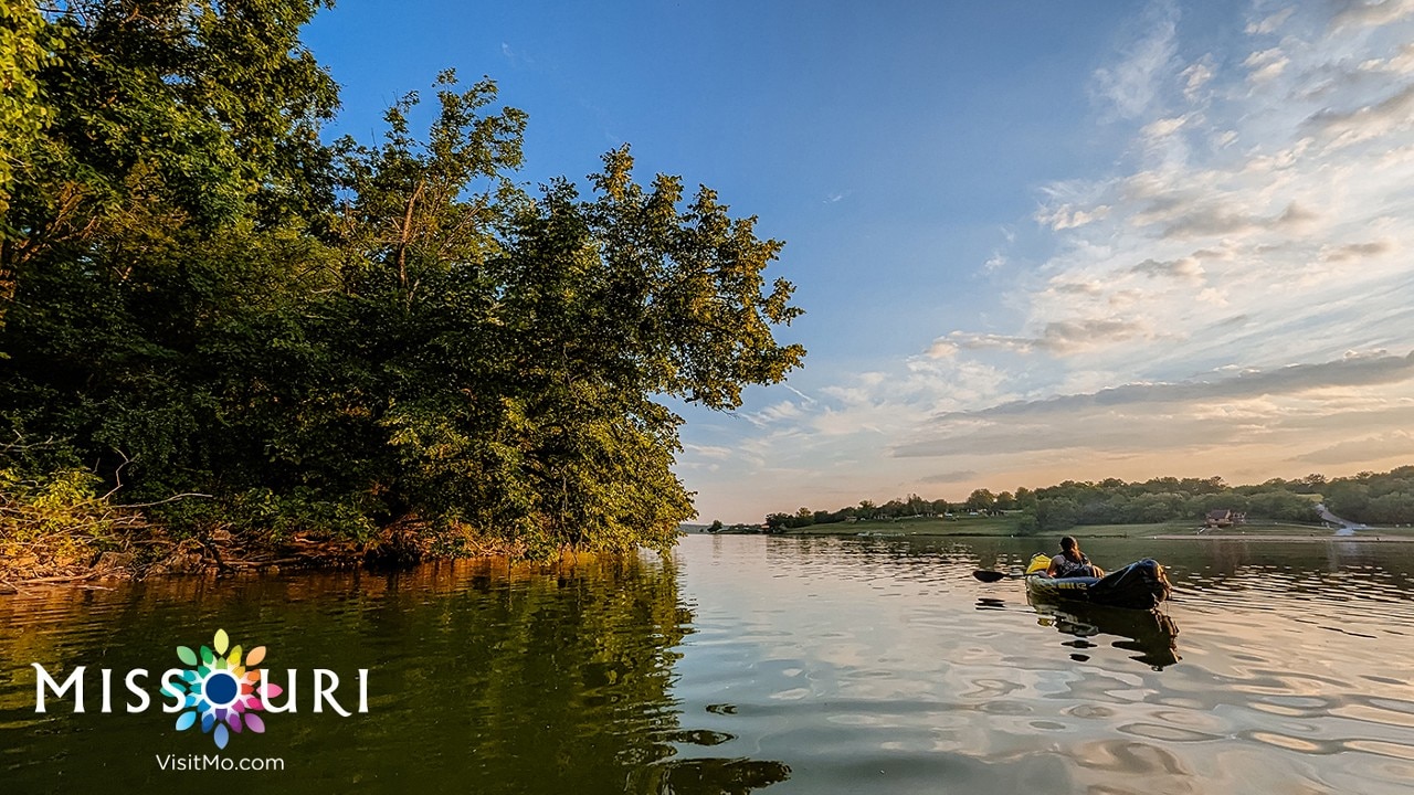Kayaking Forest Lake by Brendon Wilson. Missouri. VisitMO.com logo.